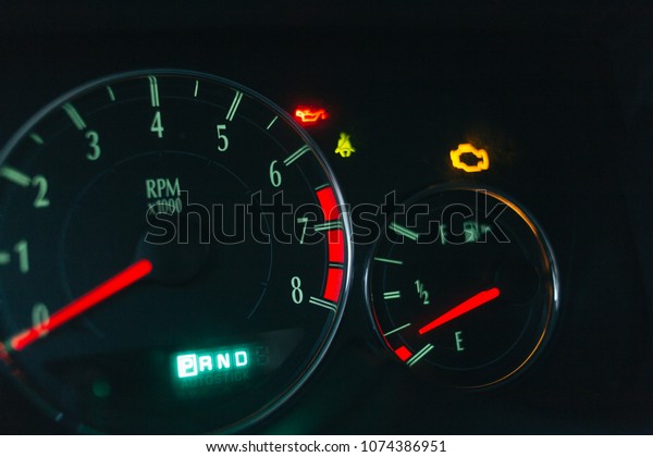 car dashboard with\
check engine light on 