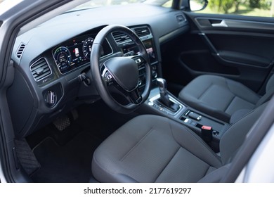 Car Dashboard With A Digital Touchscreen. Steering Wheel Of A Electric Vehicle, Interior Cockpit, Electric Buttons, Digital Speedometer, Front Seats, Textile, Windows, Console, Gear Shift.