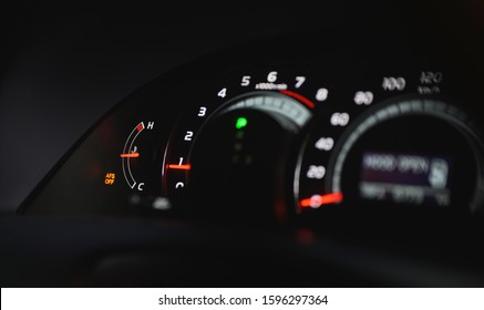 Car dashboard focus on water temperature gauge at ideal temperature.