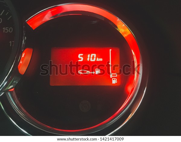 car dashboard lights with range until gas
runs off fuel range red light and car
symbol