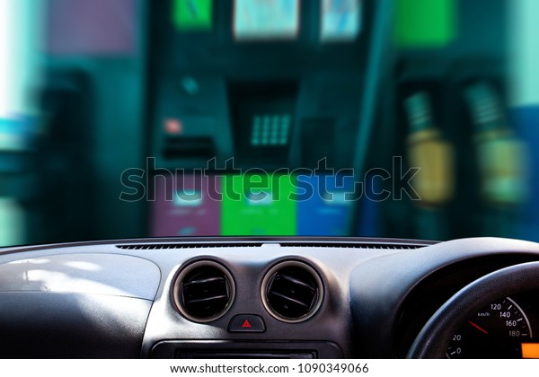 Car dashboard over petrol\
station\
