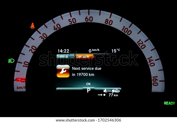 Car dashboard panel with display indicates when\
service is needed. Car cluster with speedometer, seat belt reminder\
and dipped beam headlights icon in full electric vehicle. Car\
inspection reminder.