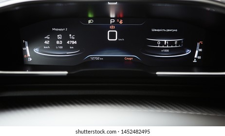 Car dashboard panel with speedometer, tachometer, odometer, fuel gauge and gear position indicator.