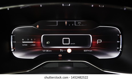 Car dashboard panel with speedometer, tachometer, odometer, fuel gauge and gear position indicator.