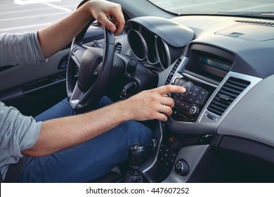 Car Dashboard. Radio Closeup. Man Sets Radio