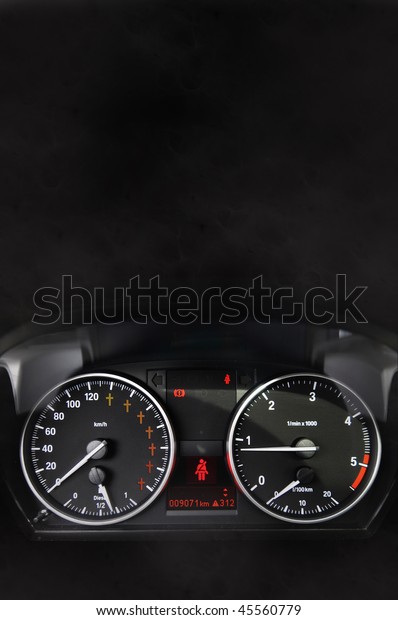 Car\
dashboard with red crosses in the\
speedometer