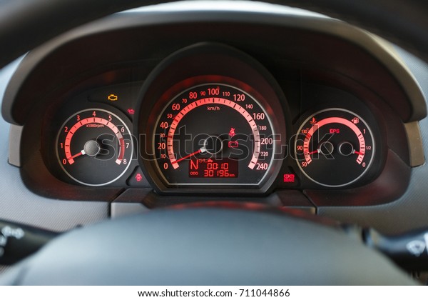 Car dashboard with red\
light, close