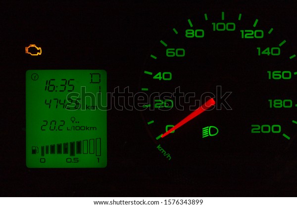 Car dashboard -\
speedometer and on-board computer screen. Сontrol lamp “CHECK\
ENGINE” is on. Front view.