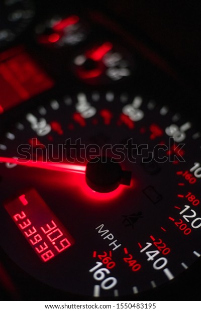 car dashboard. Speedometer with red\
backlight at night close up. Vertical\
photo