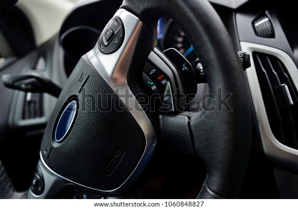 Car dashboard\
and steering wheel inside of\
car.