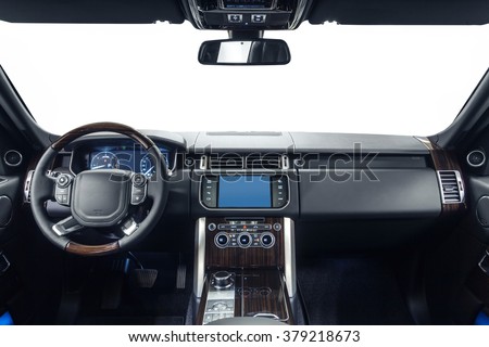 Car dashboard & steering wheel. Interior of prestige modern car. Black cockpit with exclusive wood & metal decoration on isolated white background.