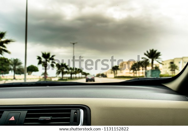 a car
dashboard view and clouds in the background
