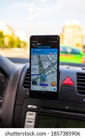 In Car Dashboard View With Smartphone Showing Police On Waze Maps. Driver Using Waze Maps In Bucharest, Romania, 2020