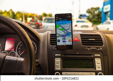 In Car Dashboard View With Smartphone Showing Police On Waze Maps. Driver Using Waze Maps In Bucharest, Romania, 2020