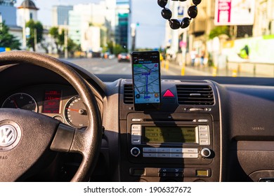 In Car Dashboard View With Smartphone Showing Police On Waze Maps. Driver Using Waze Maps In Bucharest, Romania, 2021