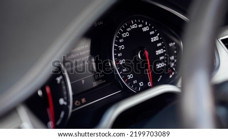 Car dashboard with white backlight: Odometer, speedometer, tachometer, fuel level, water temperature and more.