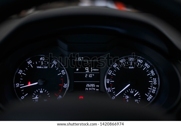 Car dashboard with white illuminated\
instruments and arrows. Car\
dashboard.