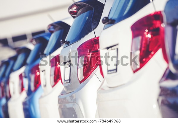 Car Dealer Business\
Concept. Row of Brand New Compact Cars on the Dealer Lot.\
Transportation Industry.