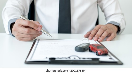 Car Dealer Businessman Signing Car Insurance Document Or Lease Paper. Car Loan And Insurance Concept.