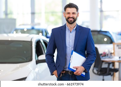 Car dealer in showroom
 - Shutterstock ID 661973974