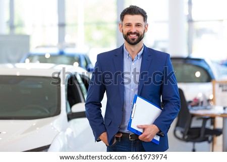 Car dealer in showroom
