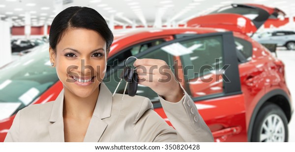 Car dealer woman. Auto dealership and rental
concept background.