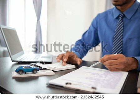 Car dealers have brought out documents and calculators to calculate interest rates and notify car payment to customers before signing purchase contract for accuracy. using calculator to get accurate
