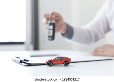 Car Dealers Or Insurance Managers Cover And Protect Against Damage And The Risk Of Driving, Hold The Car Keys, Protecting And After-sales Care Concept.