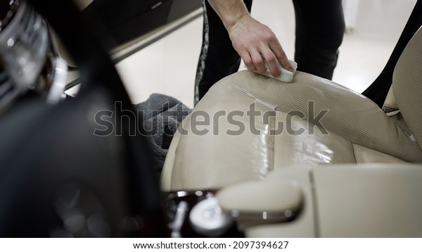 Car dealership\
dry cleaning. Detailing and cleaning of back seats at luxury modern\
car. Car interior washing.