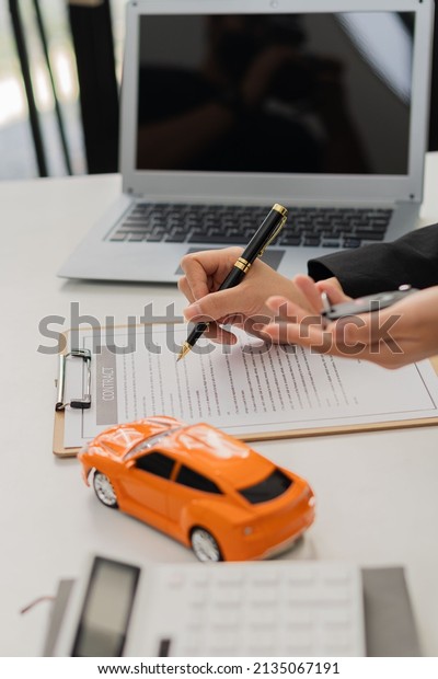 Car dealership offices offer car sales contracts\
at their desks.