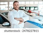 Car dealership, portrait or happy man with arms crossed for vehicle, finance or confidence. Welcome, smile or proud salesman in showroom ready for business, transportation or consultant by automobile