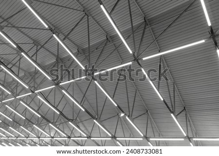 car dealership or repair detailing shop ceiling with linear beam flooding light.