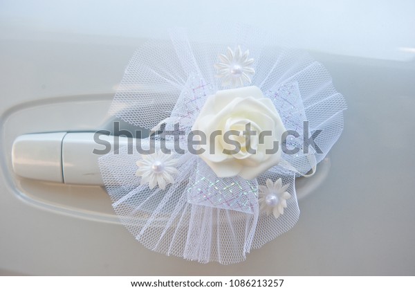 Car decoration for a wedding of delicate artificial\
colors of white color