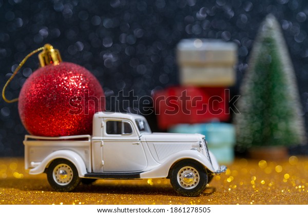 Car - delivery of\
Christmas gifts. Beautiful festive Christmas composition of gifts\
and toys.