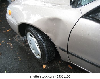 Car with dent  on driver side.