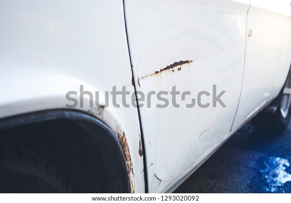 Car with dent\
on driver side from car\
accident