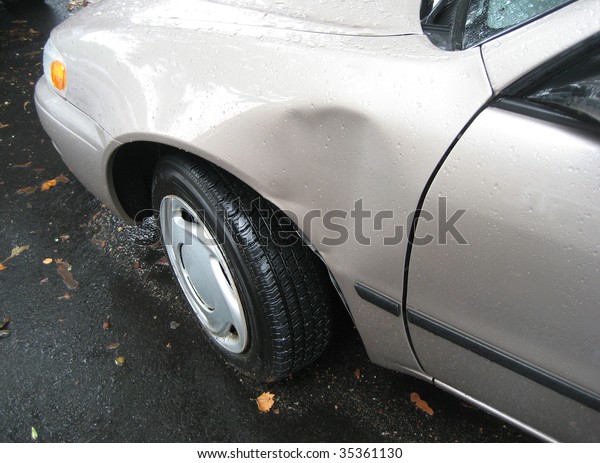 Car with dent  on driver
side.