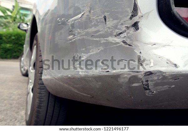 Car dents and paint scratches on the left body\
after car crash accident.