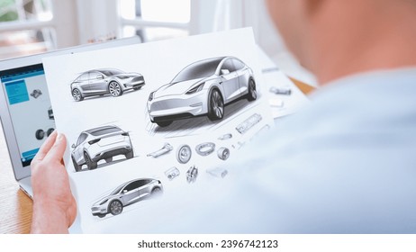 Car design engineer analyze car prototype for automobile business at home office. Automotive engineering designer carefully analyze, finding flaws and improvement for car design with laptop Synchronos