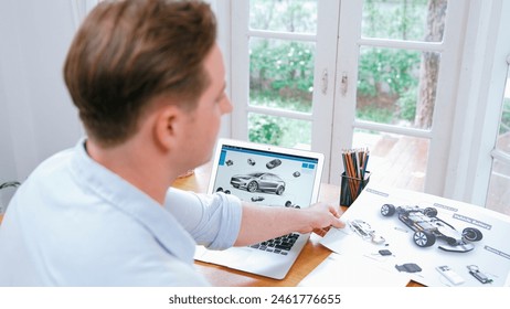 Car design engineer analyze car prototype for automobile business at home office. Automotive engineering designer carefully analyze, finding flaws and improvement for car design with laptop Synchronos