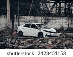 car and destroyed buildings of the workshop of the Azovstal plant in Mariupol war in Ukraine with Russia