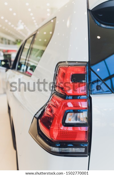 Car\
detail. New led taillight by night. The rear lights of the car, in\
hybrid sports car. Developed Car\'s rear brake\
light.