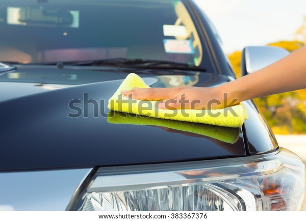 Car detailing and cleaning by hand and microfiber\
towel. Polishing the car exterior with car shine products or wax\
result in shine surface.\
Car care service concept with washing,\
cleaning, waxing etc.