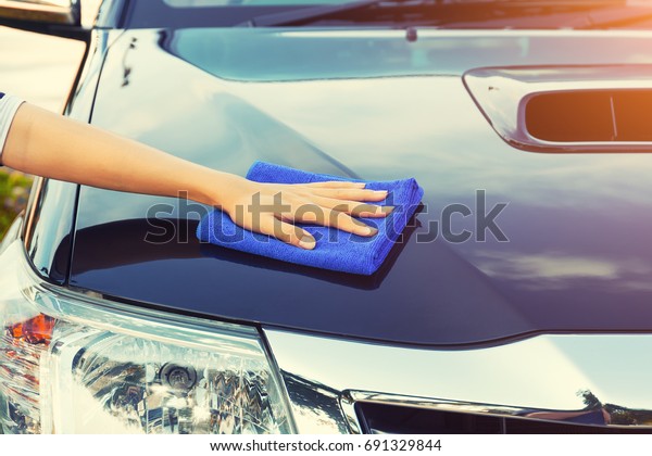Car detailing and cleaning by hand and microfiber\
towel. Polishing the car exterior with car shine products or wax\
result in shine surface.\
Car care service concept with washing,\
cleaning, waxing etc.