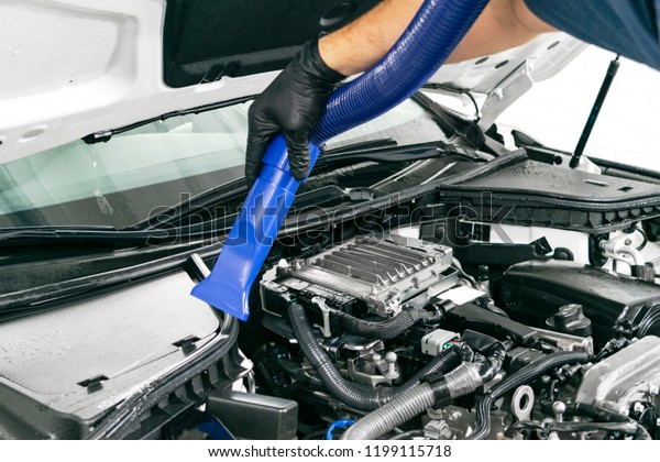 Car detailing maintenance. Cleaning engine. High\
pressure washing. Car washing concept. Car detailing. A man\
cleaning car. Cleaning\
engine