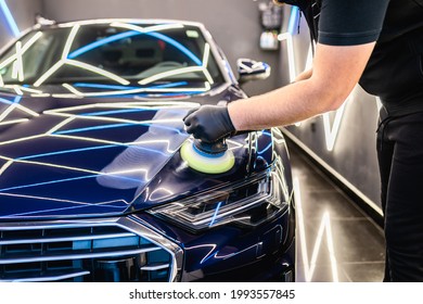 Car detailing - Man with orbital polisher in repair shop polishing car. Selective focus.	 - Shutterstock ID 1993557845