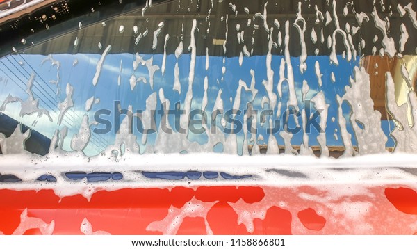 Car Detailing Process. Spray Foam bubble shampoo\
on the car surface.