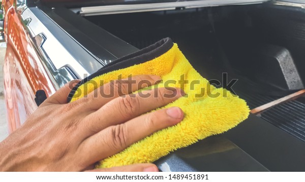 Car Detailing Process. Waxing Car Surface and Wipe\
off with microfiber cloth.