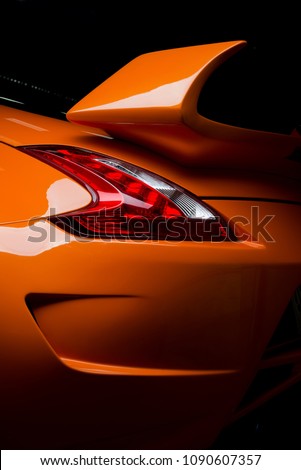 Car detailing series: Clean of rear orange sports car in the dark