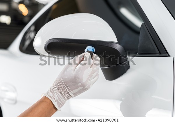 Car detailing series : Closeup of hand  coating\
plastic part